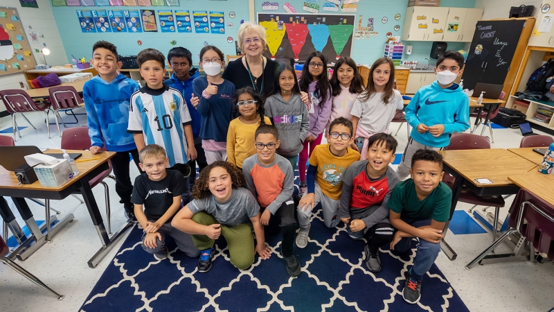 Ms. Bunni sits with group of students