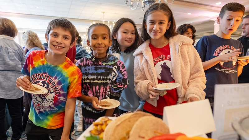 Students smile as they taste test a potential new recipe for FCPS cafeterias.