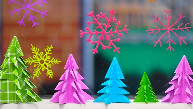 Colorful paper trees and snowflakes.