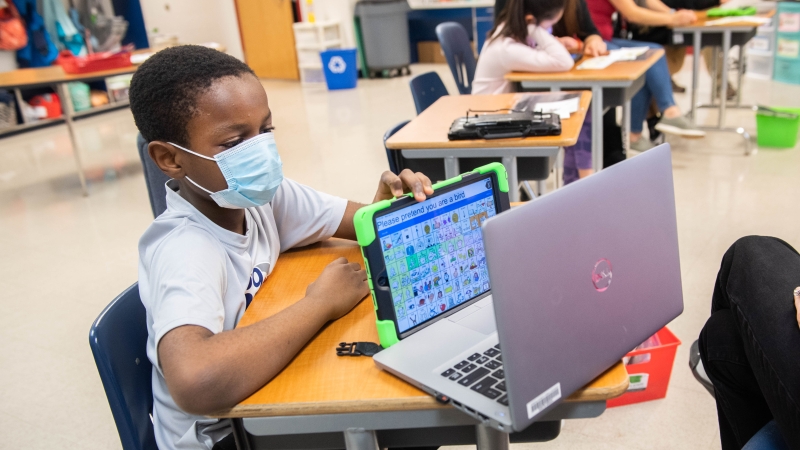 A student participates in a TJ AT Club meeting. 