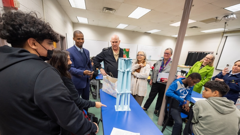 Students test their paper towers. 