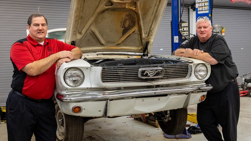 Dominic Prakash and David Plum in the auto shop