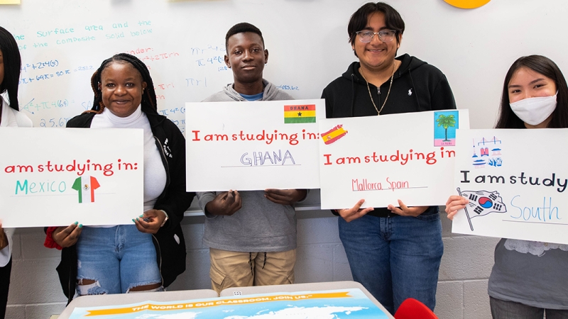 Five Annandale High School students hold signs noting their summer study abroad scholarship destinations.