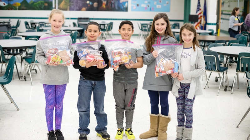 students with meals they packaged