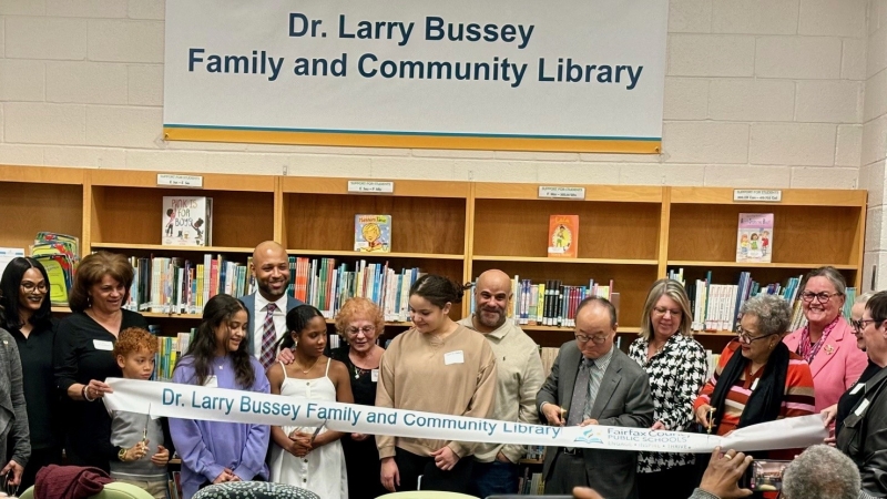 A ribbon cutting ceremony in a library