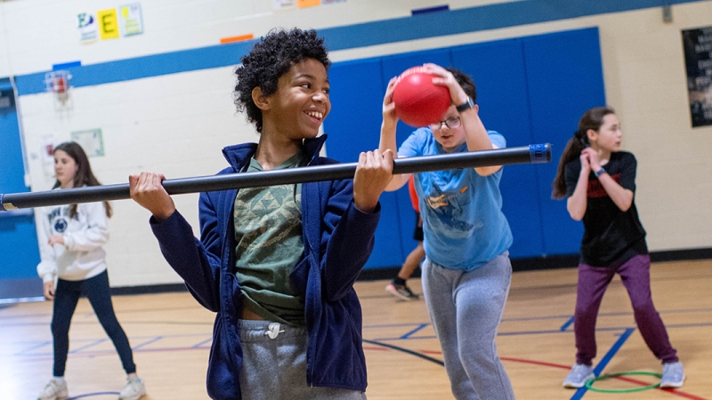 Students lift weights and stretch during a before-school exercise program known as Fitness Warriors at Chesterbrook Elementary School.