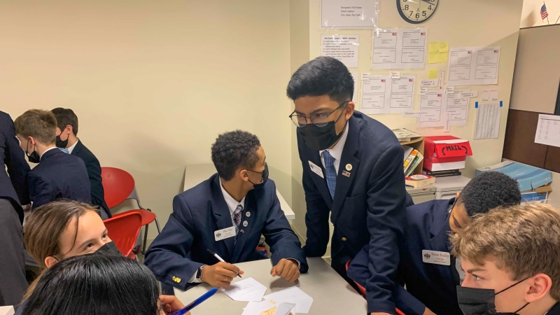 Whitman Middle School Eighth-Grader Diego Orendain hashes out plans for the day with other Virginia Senate pages in Richmond.