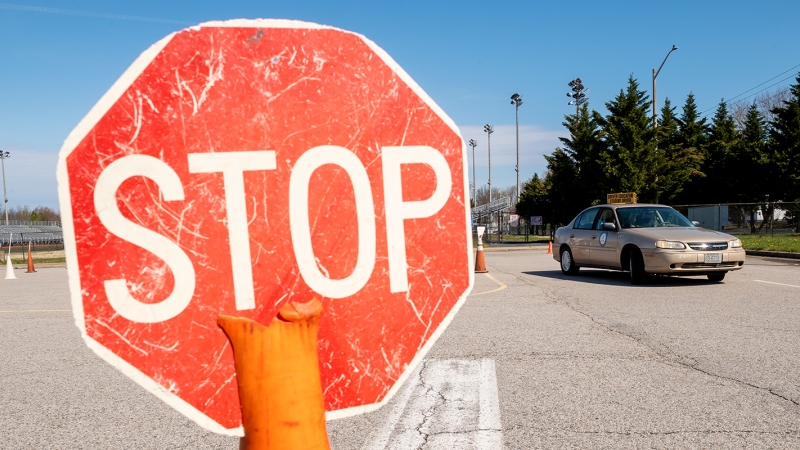 stop sign in the foreground and a driver education car in the background