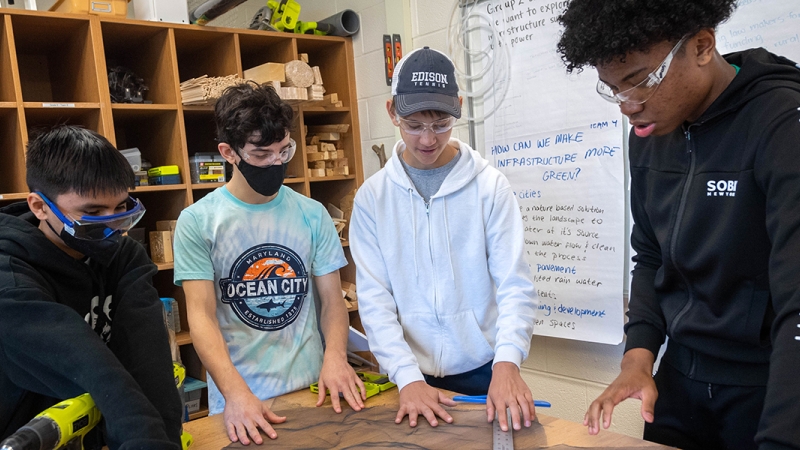 Global Stem Challenge Program students construct a crate to house mealworms who will feast on plastic and styrofoam.