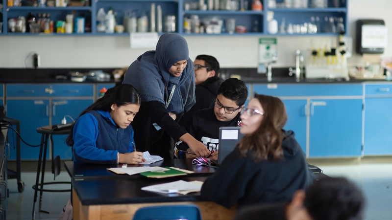 science teacher with students in lab