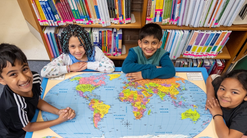 students looking at world map