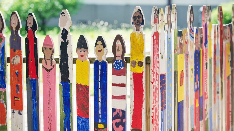 Colorful fence of painted faces
