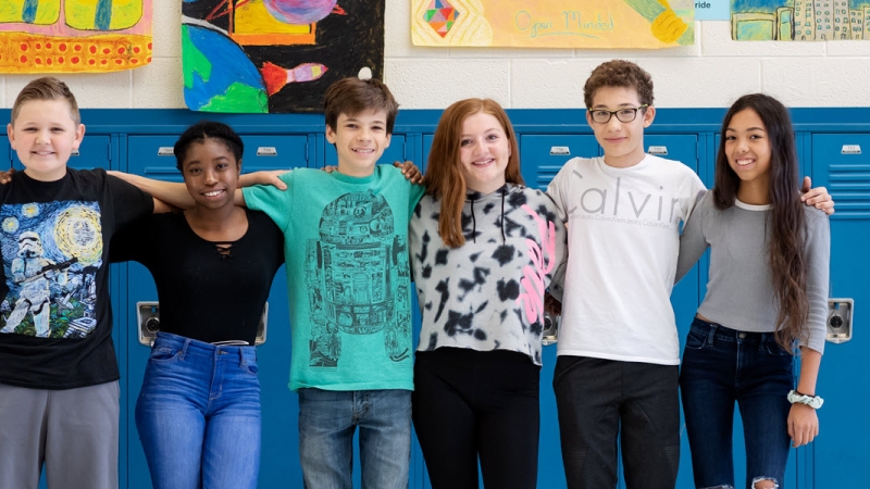 middle school students in front of lockers