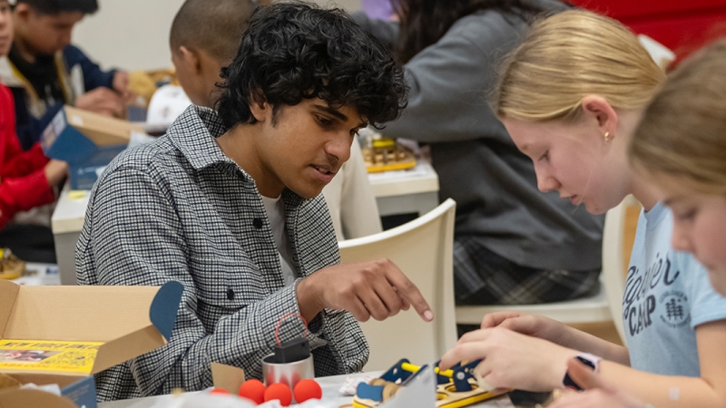 Students work on a laser catapult kit at the grant award ceremony held at Herndon Middle School.