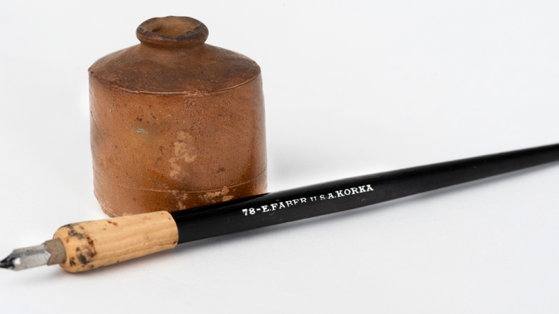 Photograph of an old ink pen and ink jar used by Fairfax County Public Schools students.