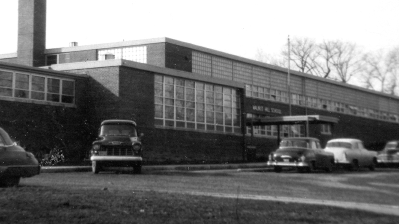 Black and white photograph of the front exterior of Walnut Hill Elementary School.