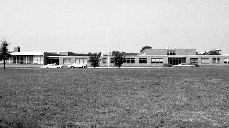 Black and white photograph of Bryant Intermediate School. The photograph was taken in July 1969 from a vantage point along Quander Road and shows the full length of the front of the building.