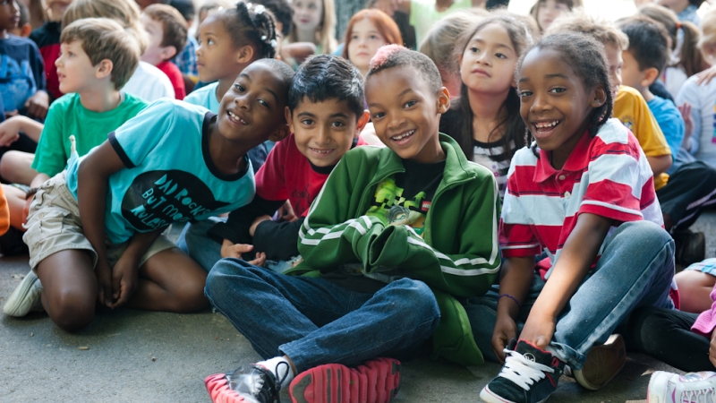 students from Lake Anne Elementary School sitting on floor