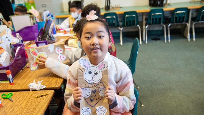 A Powell Elementary student displays a bunny puppet she made to celebrate the Year of the Rabbit.