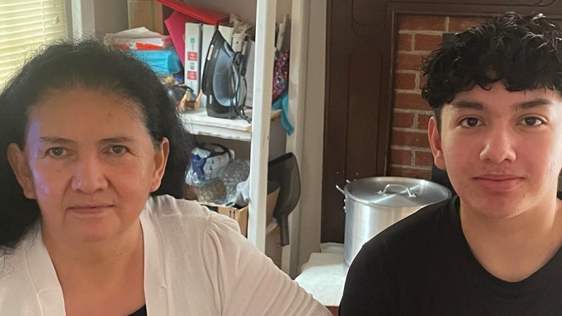 Marshall High School rising sophomore Andy Campos sits with his grandmother, whose life he recently saved using CPR skills acquired in an FCPS physical education class.