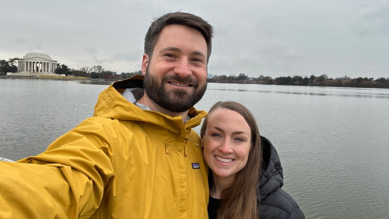 Two people smiling near DC monument