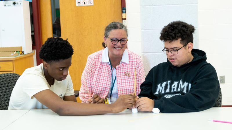 Dr. Reid with two students