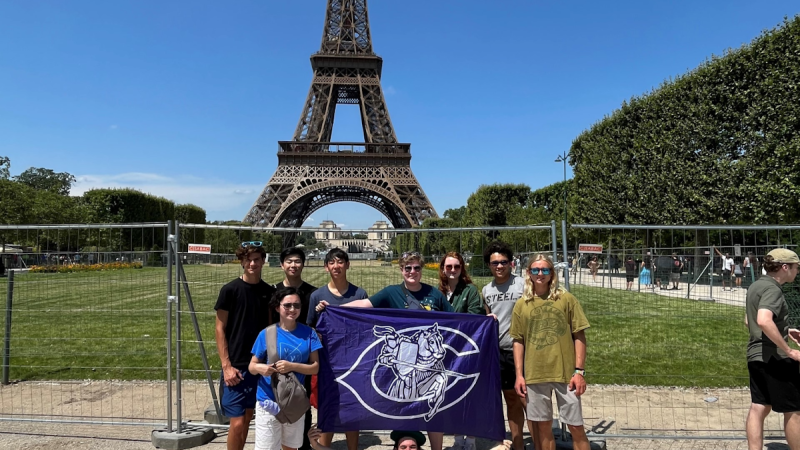 FCPS Chantilly HS students pose in front of the Eiffel Tower for the 2023 VA Ambassadors of Music