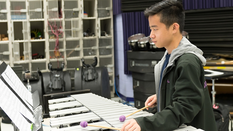 student in music class