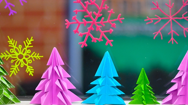 photo of Christmas trees in pink, blue and green