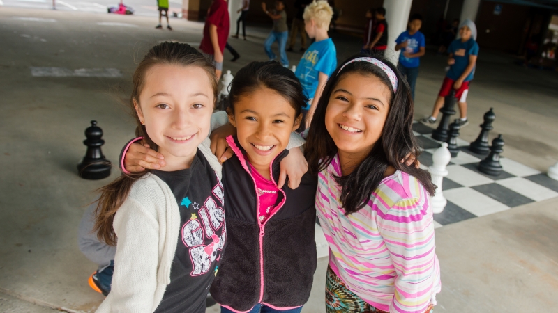 Three girls posing on playground