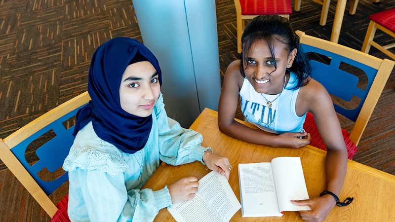 two high school students in library