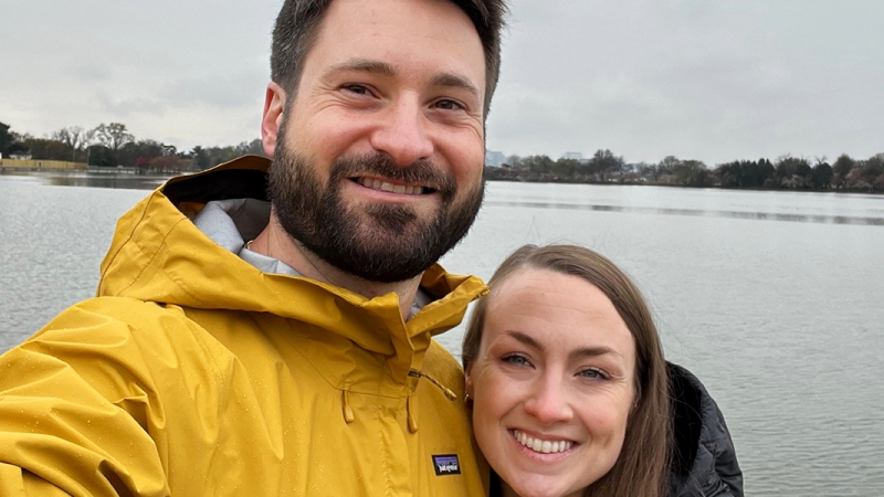 A couple takes a selfie in front of the Jefferson Memorial 