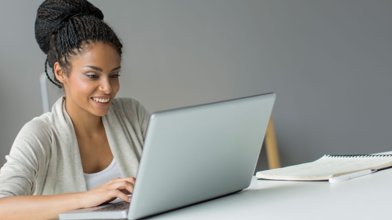 young woman using her laptop at a desk