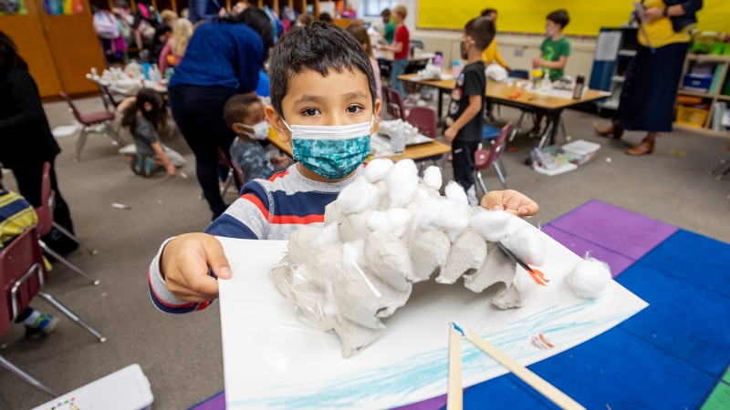 Student holding an art project.