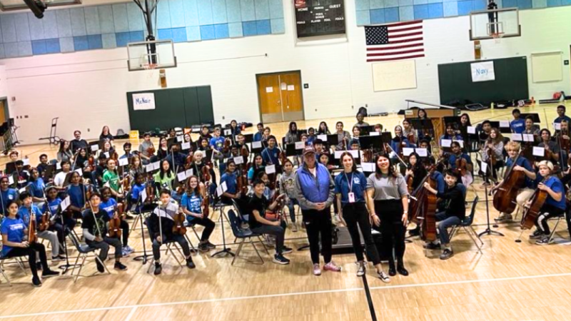 Dr. Reid with Carson and Hughes MS students at the Panther Orchestra Day