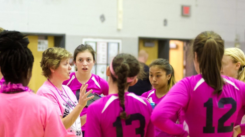 coach meeting with girls volleyball team