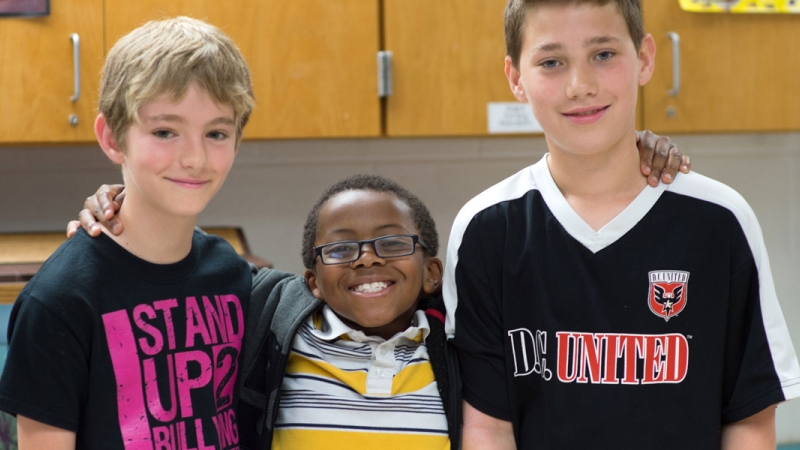 Photo of three students standing together