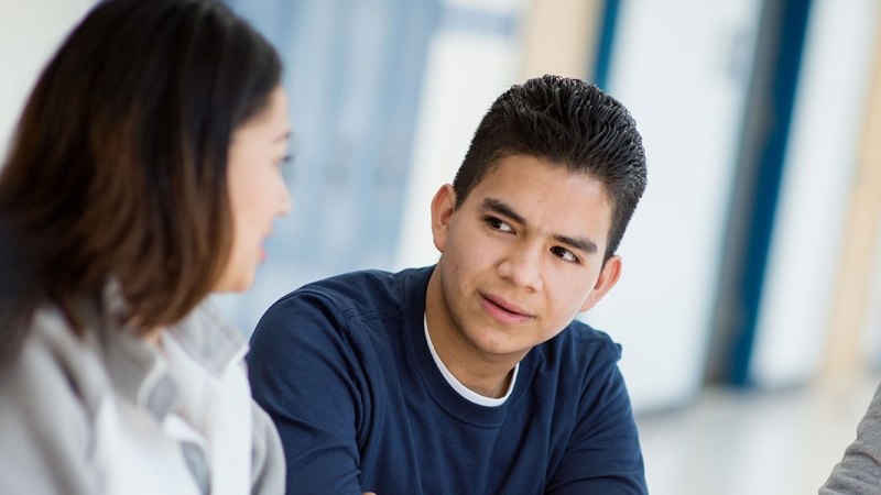 Photo of a student talking with a teacher