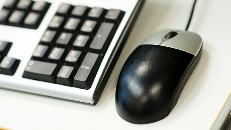 computer keyboard and computer mouse on a desk