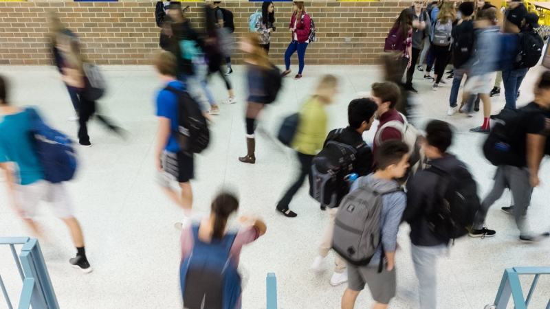 Blurred view of students walking in a school hallway