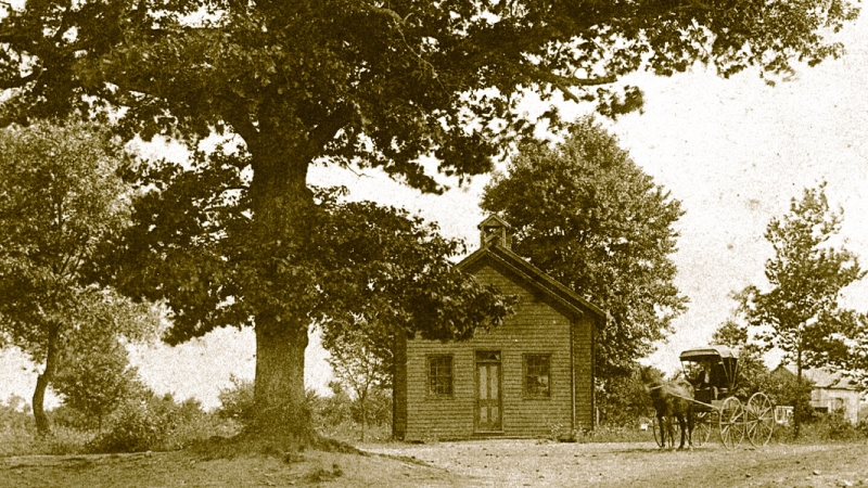 old photograph of Flint Hill schoolhouse with a horse and carriage