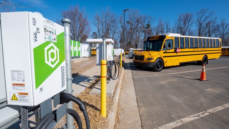 photo of electric school bus and charging station