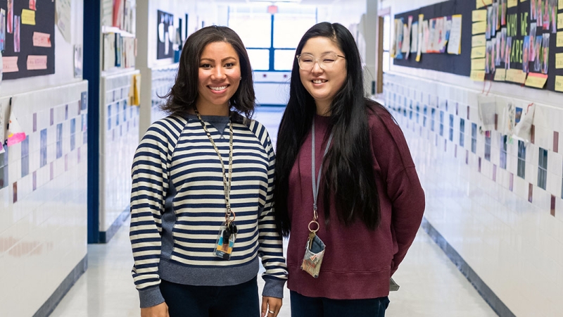 two staff members in an elementary school hallway
