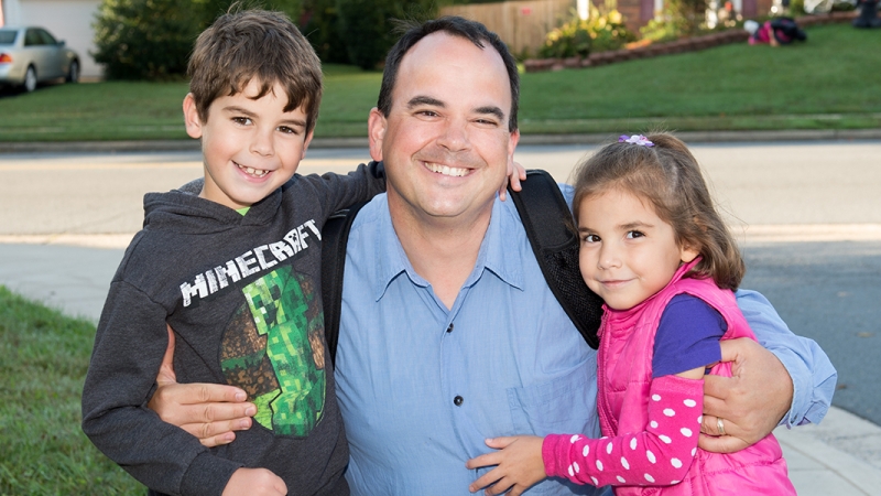 Photo of a parent with two children.