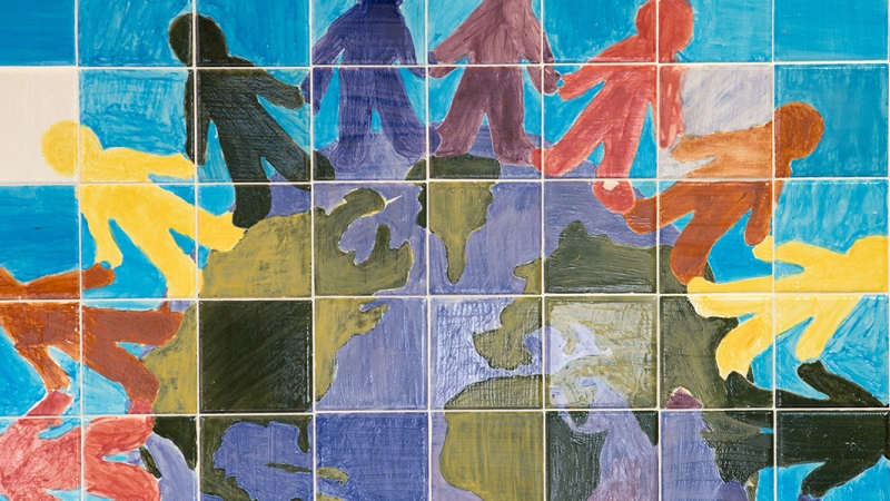 Photo of student artwork containing a globe and hands.