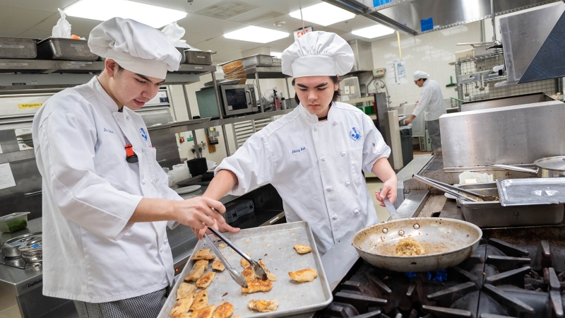 Students at the Edison Academy prepare food for guests