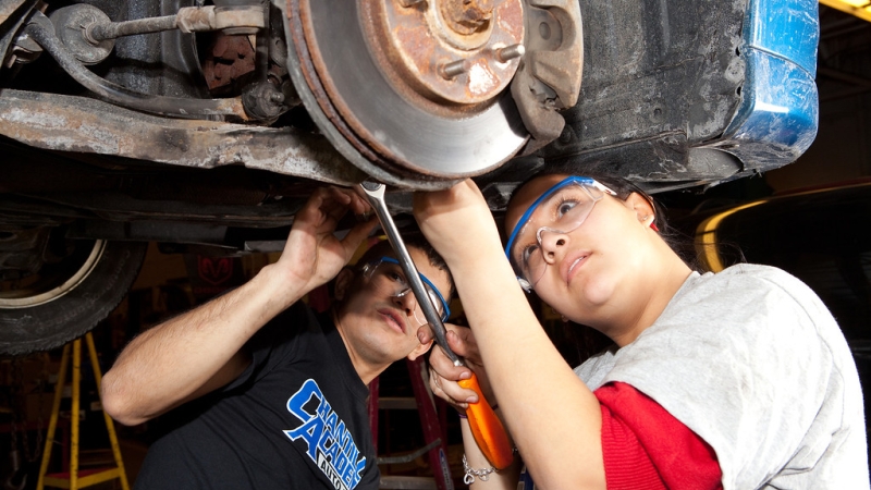 students working on car