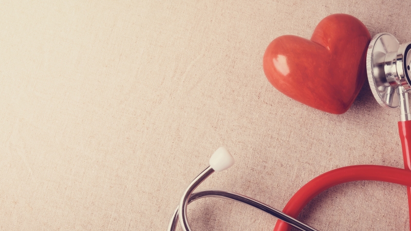 heart icon with stethoscope over a tan background