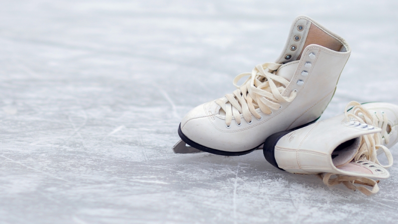 Ice skates lay on ice