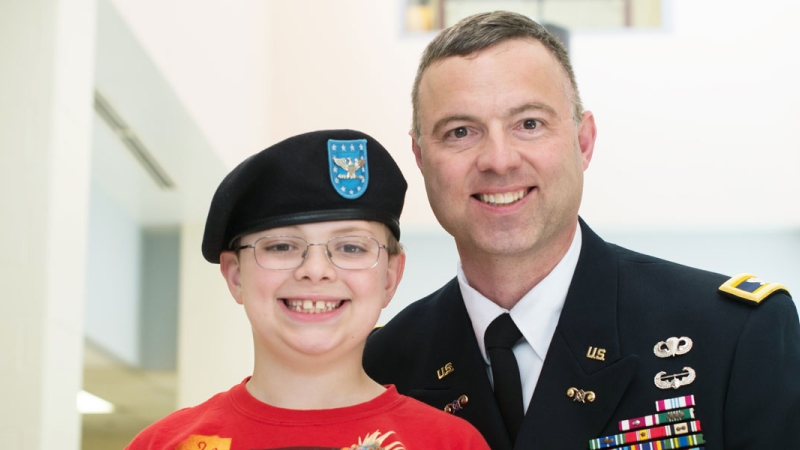 Photo of a father in a military uniform with his son
